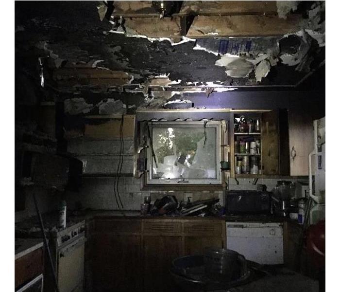 A kitchen is heavily damaged from a fire.