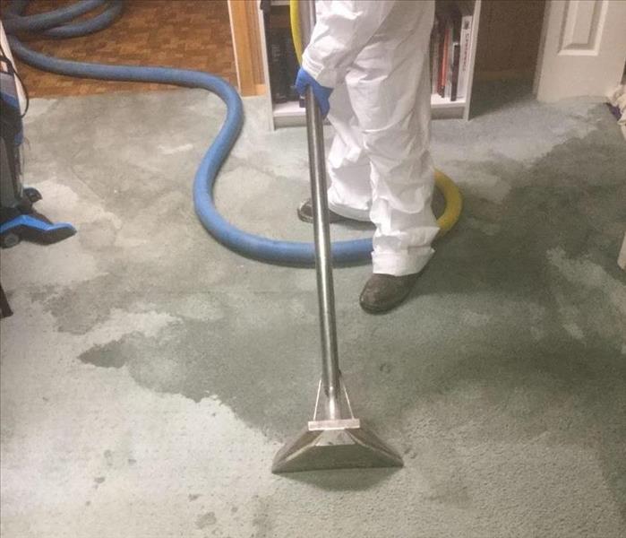 image of SERVPRO worker in full PPE performing a carpet cleaning