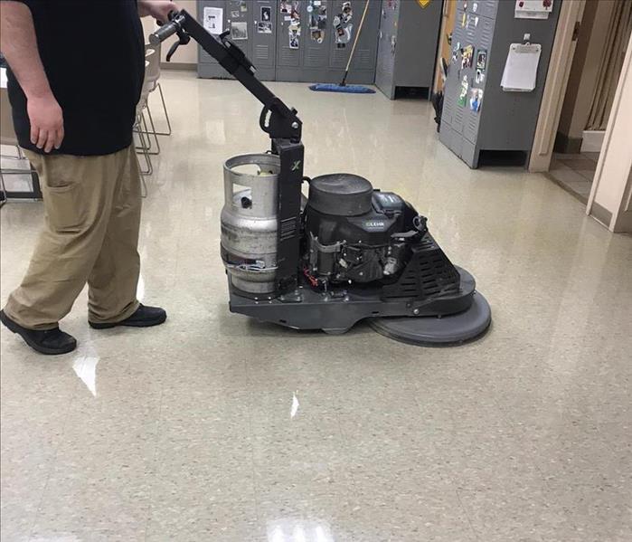 SERVPRO team member is cleaning a commercial floor.