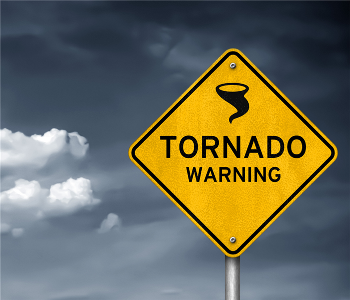 A street sign that says 'Tornado Warning'