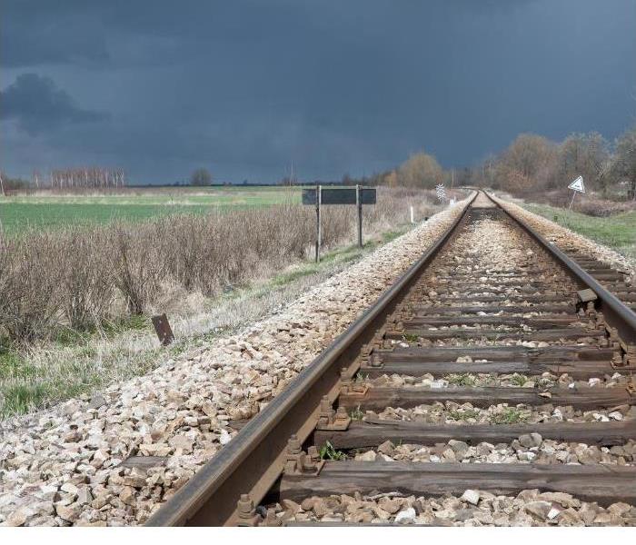 Picture shows a set of railroad tracks with a dark storm brewing in the process 